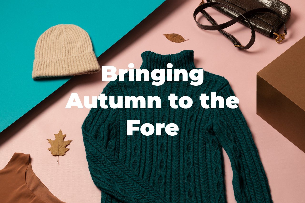 a flatlay of autumnal clothes and accessories with the words "Bringing autumn to the fore" across it